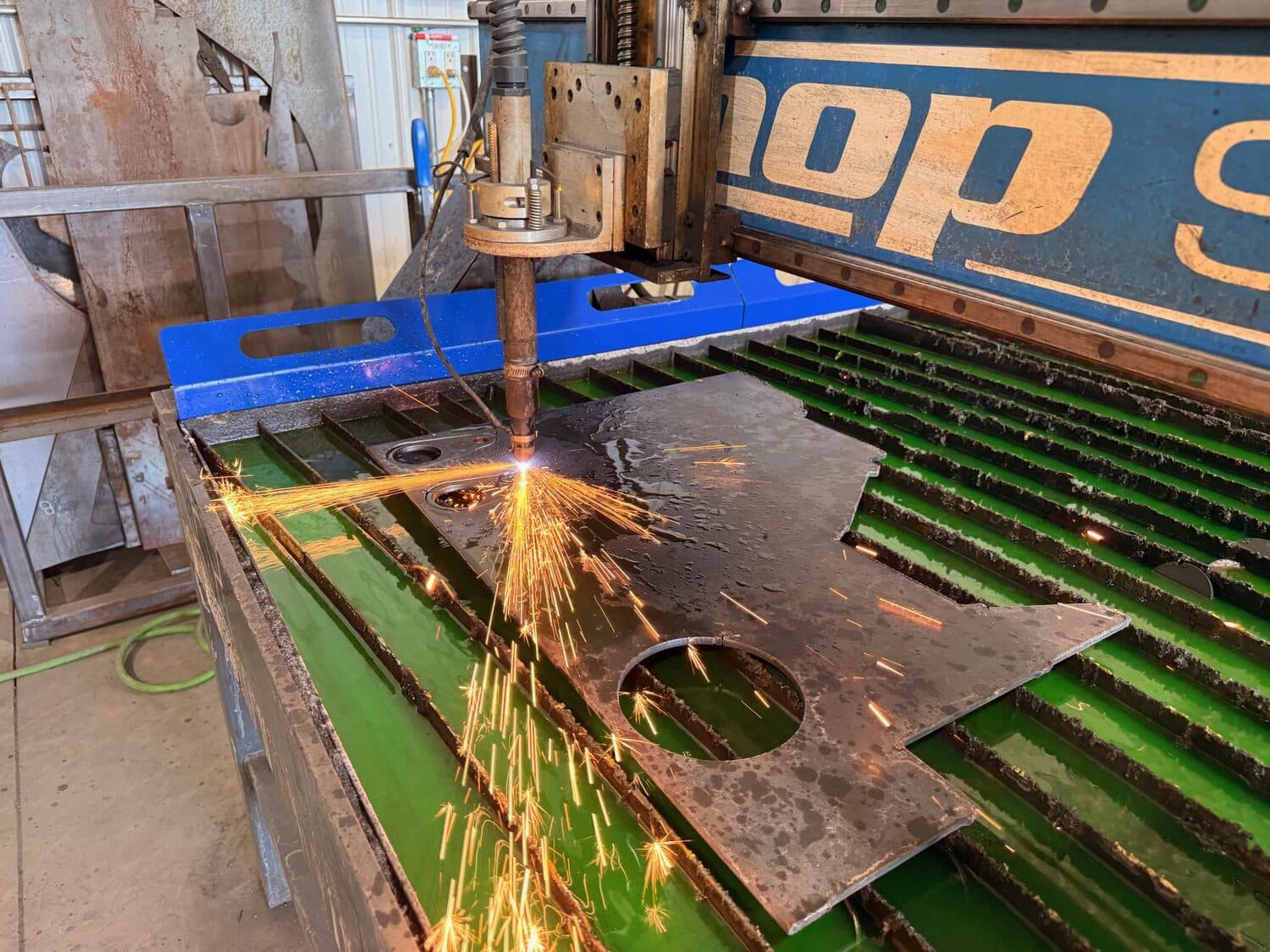 Steel plate cut to shape on the CNC plasma table, sparks flying