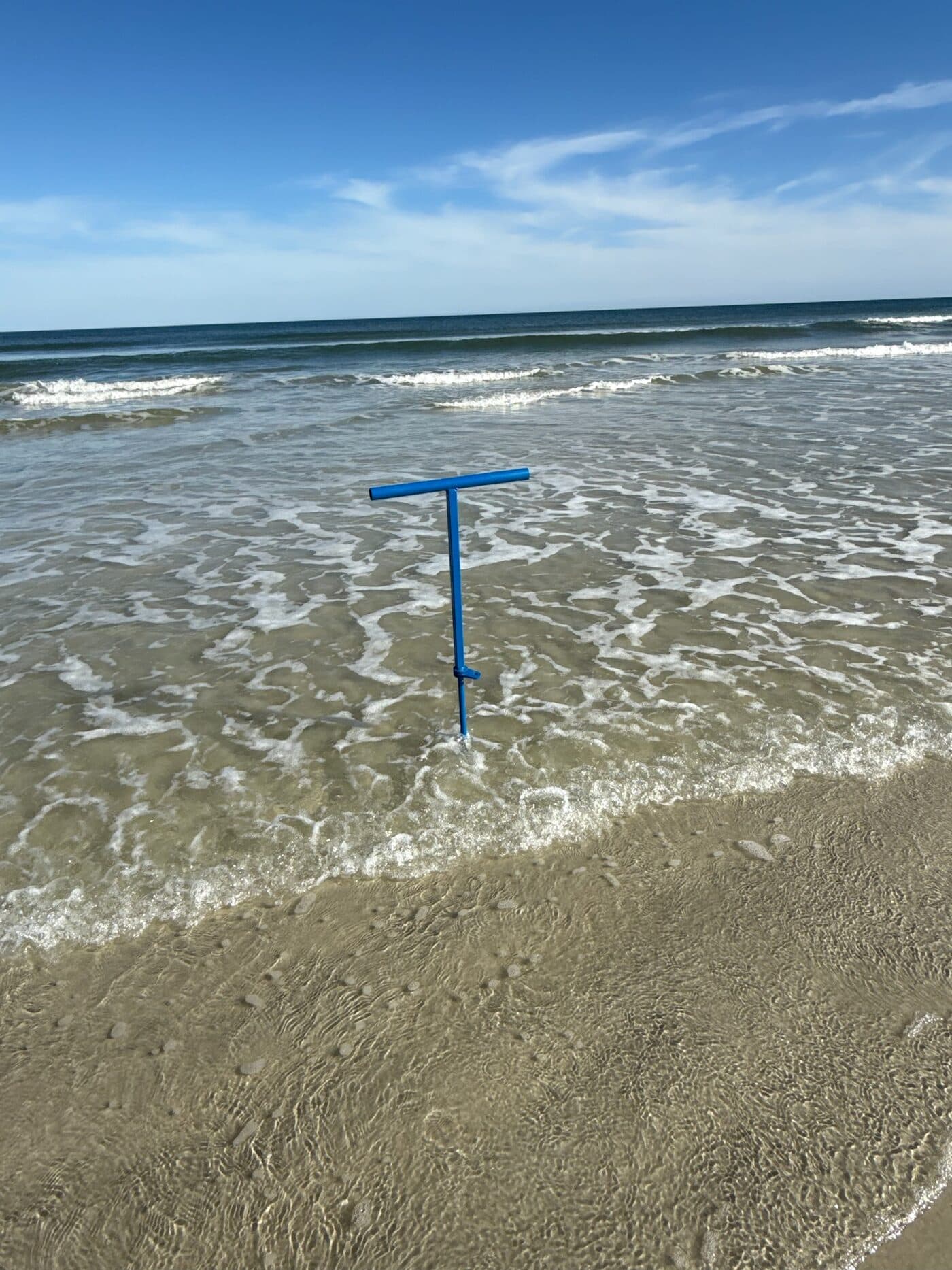 An Iron Marine anchor standing firm in the surf